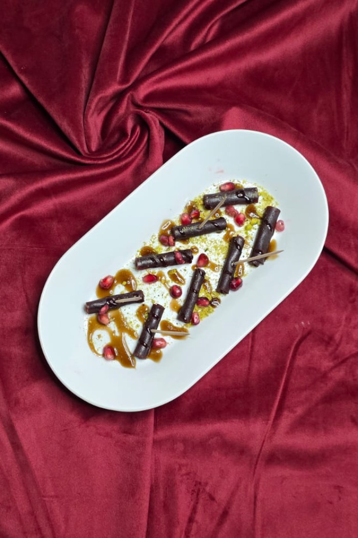 Ziba Restaurant Tart and sweet fruit leather arranged on a plate, possibly with sauce in 
Dunfermline.